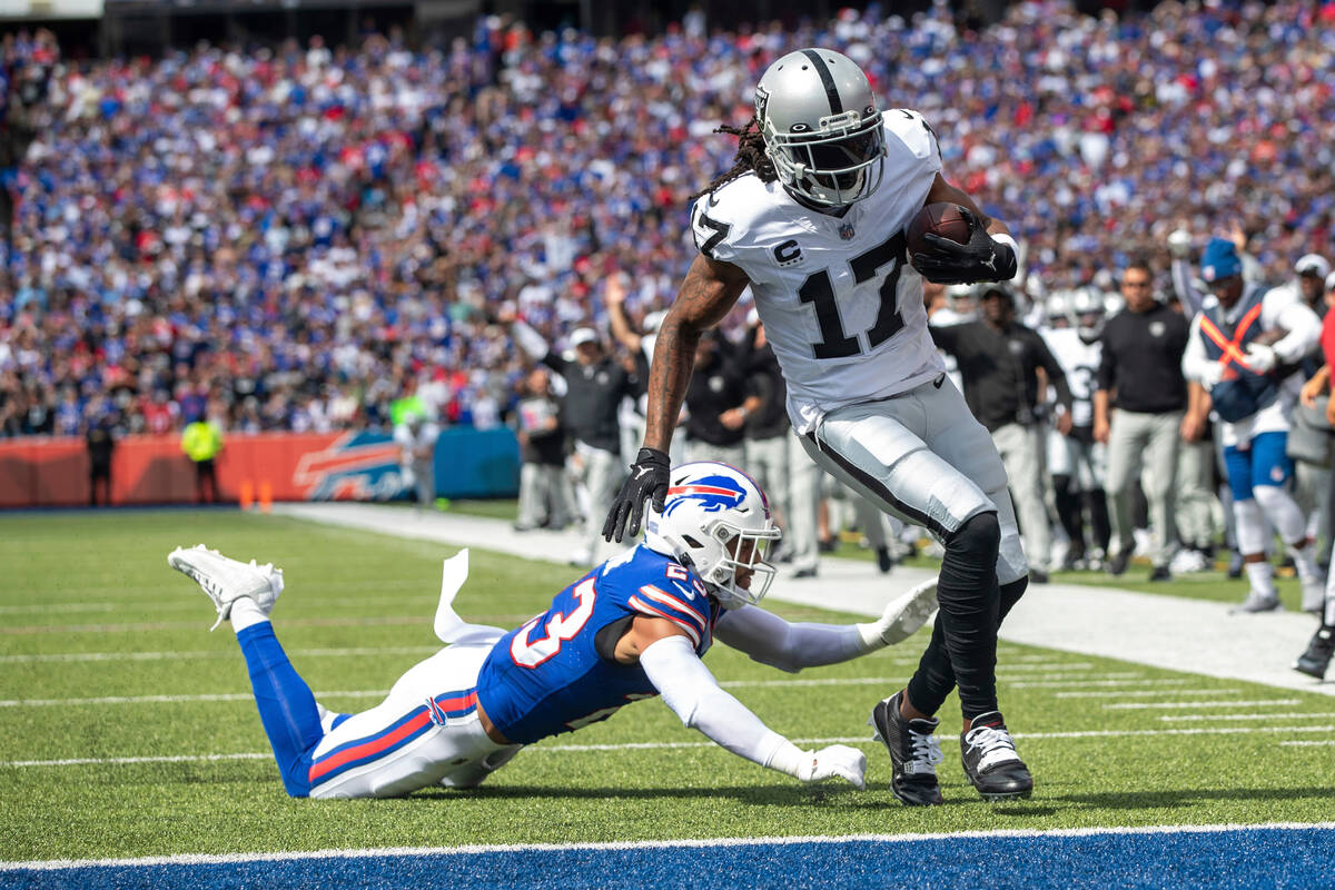 Las Vegas Raiders wide receiver Davante Adams (17) runs after the catch for a 16 yard touchdown ...