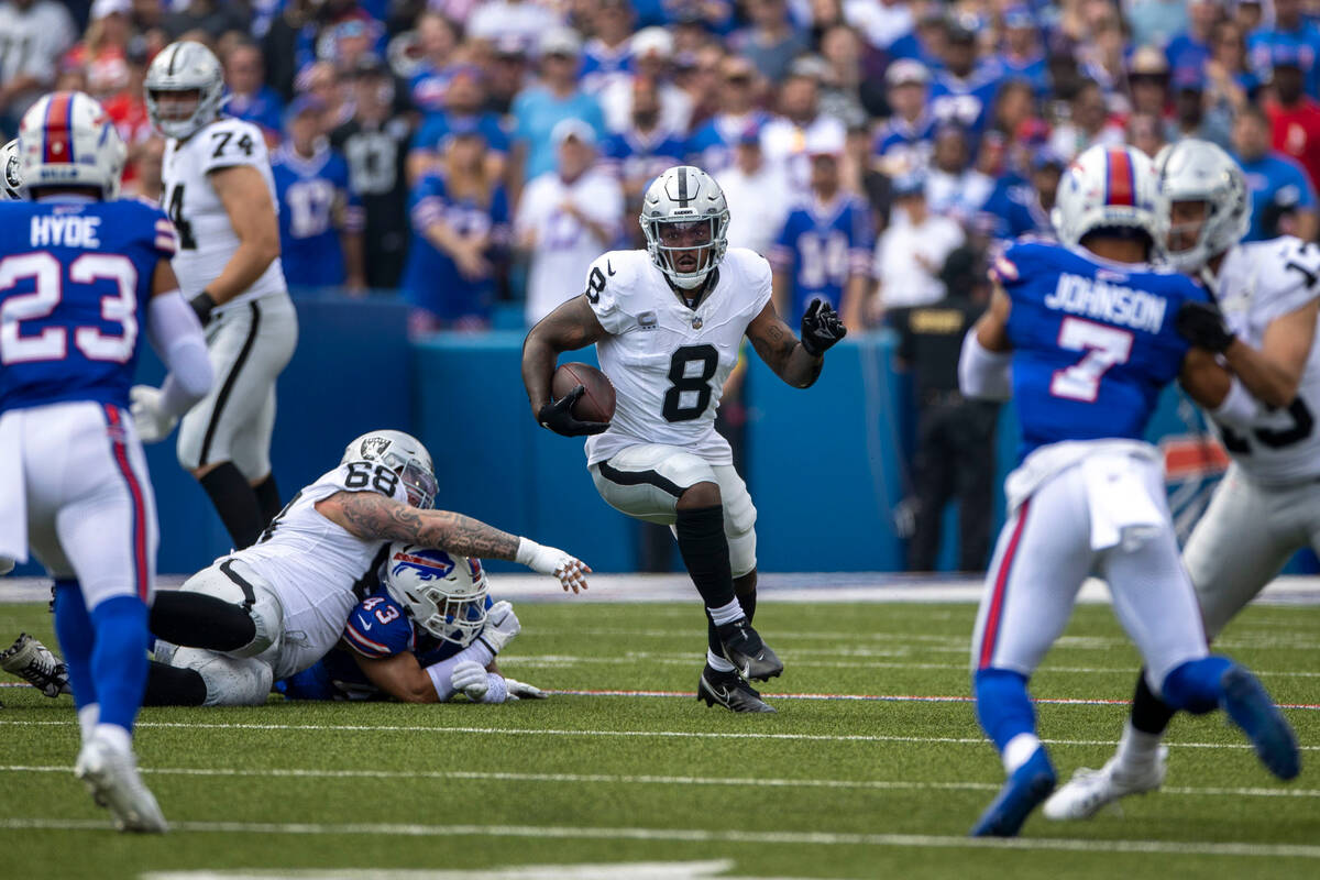 Raiders running back Josh Jacobs (8) looks for room to run against the Buffalo Bills during the ...