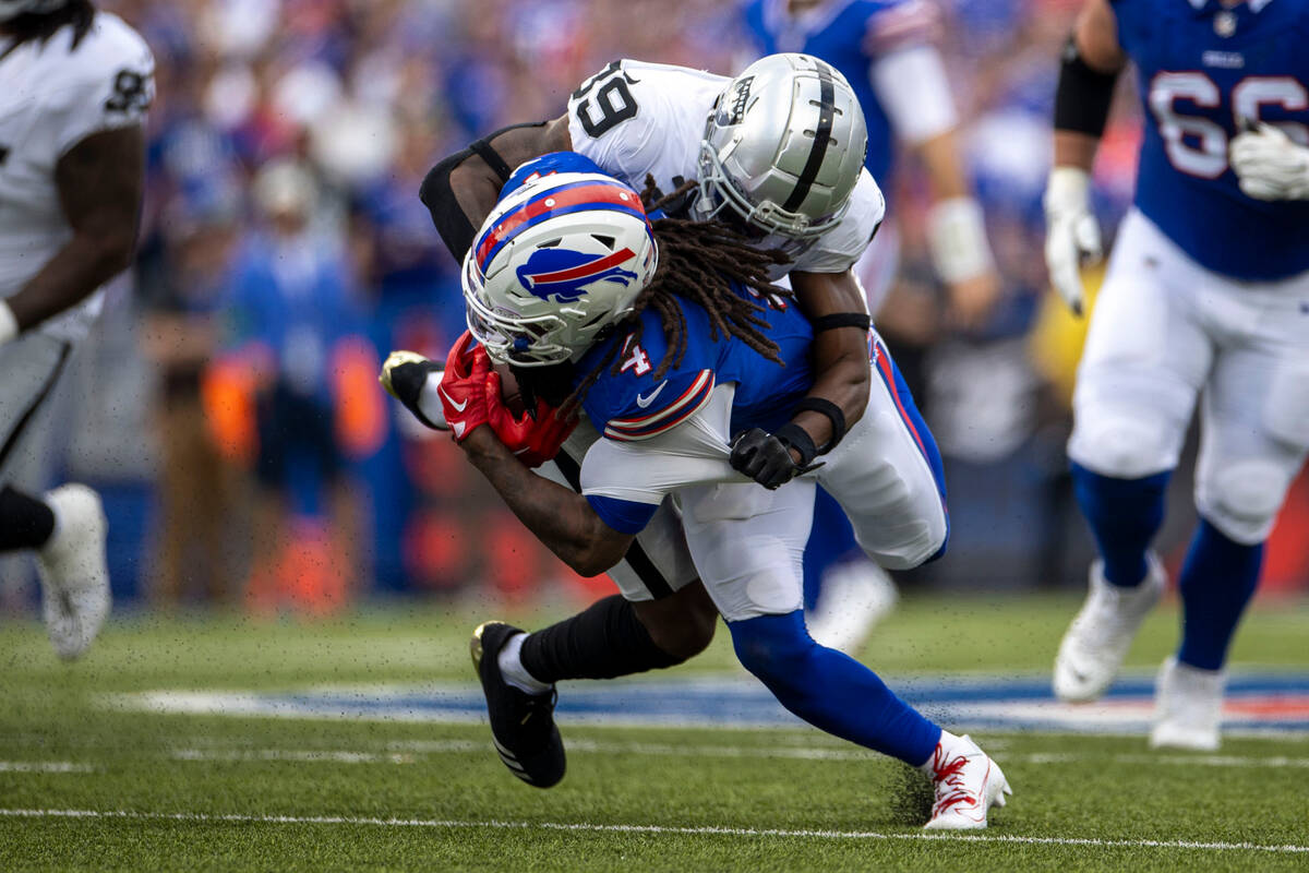 Raiders cornerback Nate Hobbs (39) tackles Buffalo Bills running back James Cook (4) during the ...