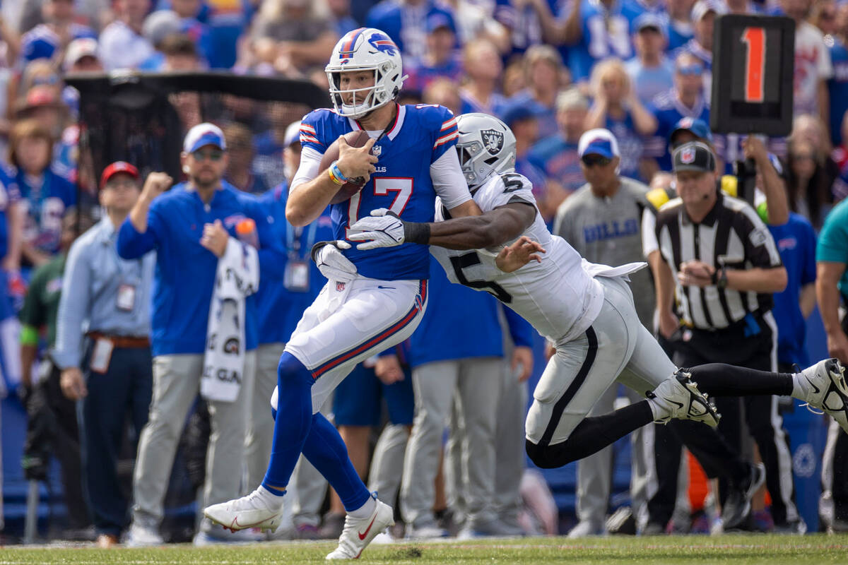 Raiders linebacker Divine Deablo (5) tackles Buffalo Bills quarterback Josh Allen (17) during t ...