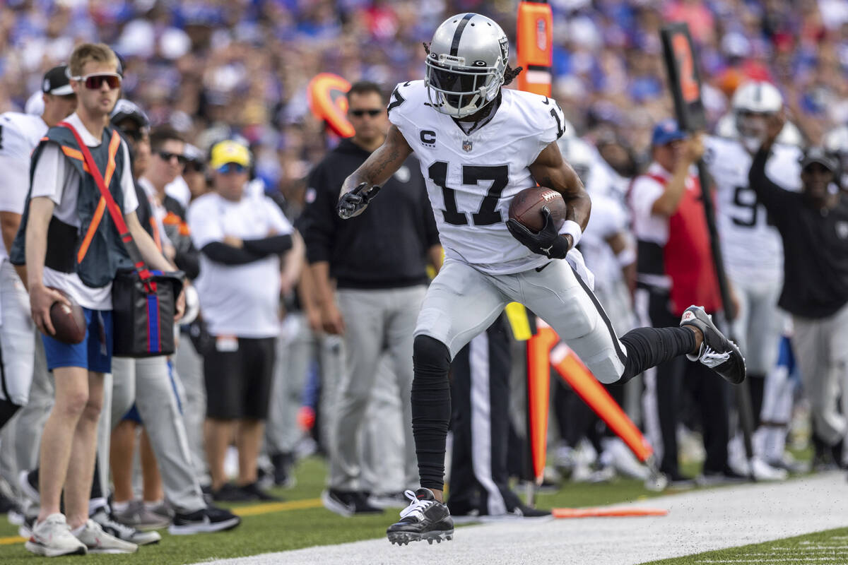 Las Vegas Raiders wide receiver Davante Adams (17) catches a pass during an NFL football game, ...