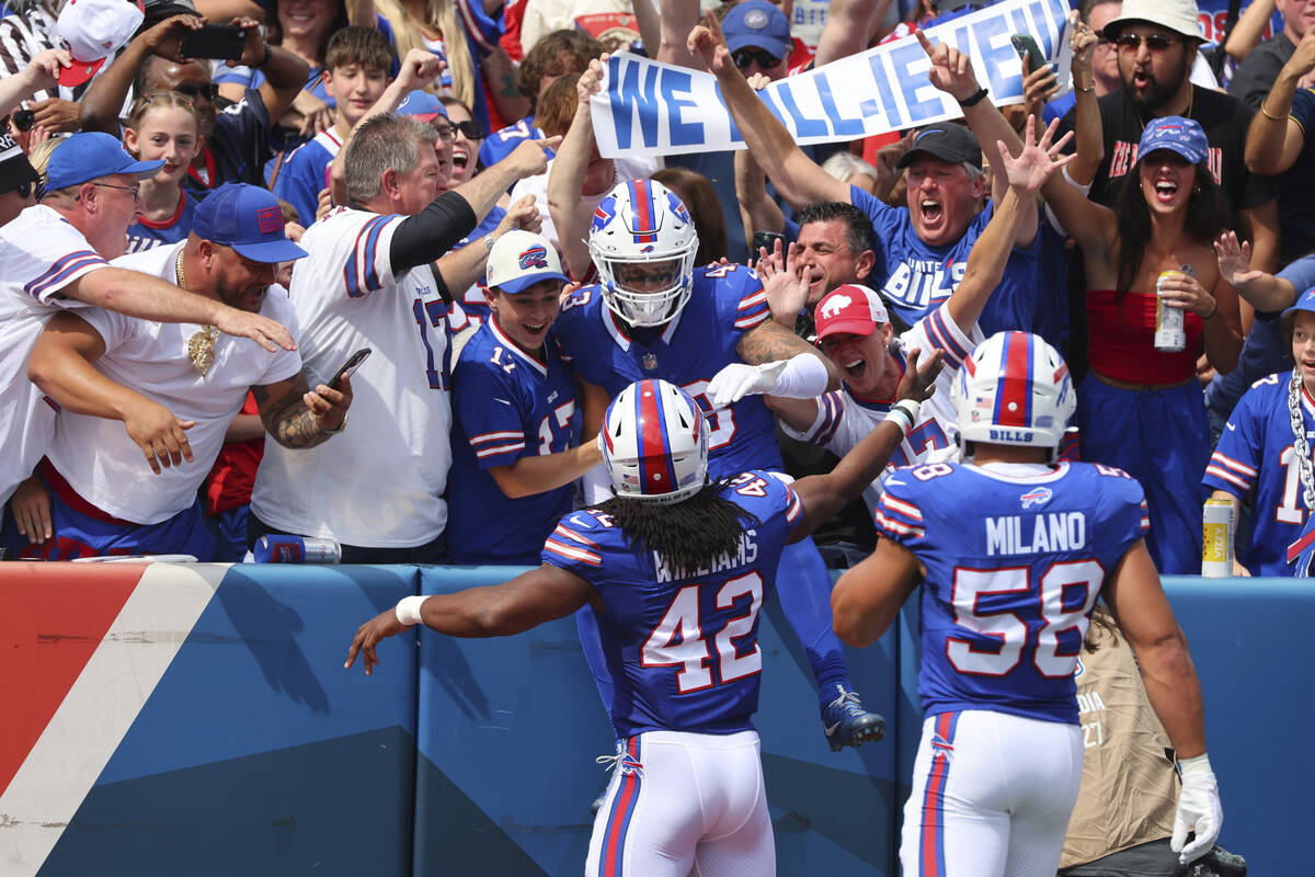 Buffalo Bills linebacker Terrel Bernard, center, celebrates with fans and teammates Dorian Will ...