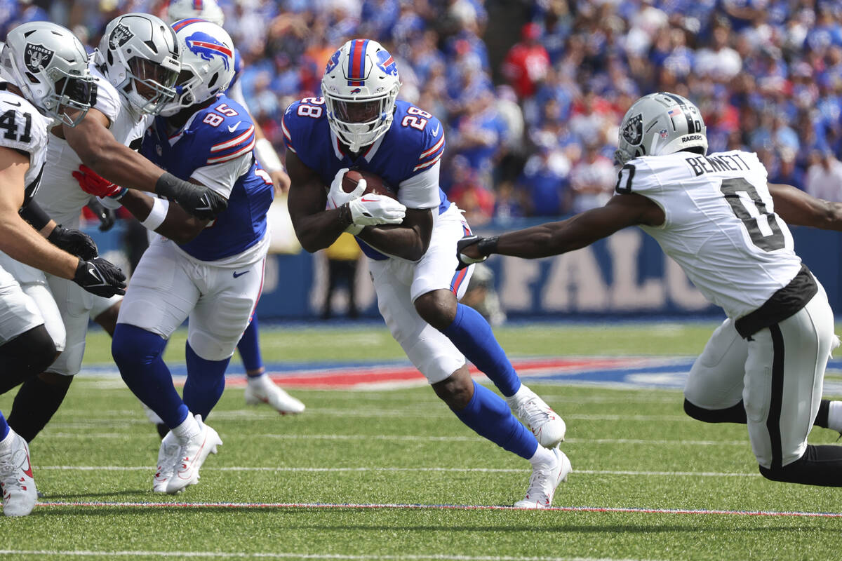 Buffalo Bills' Latavius Murray (28) rushes past Las Vegas Raiders' Jakorian Bennett (0) during ...