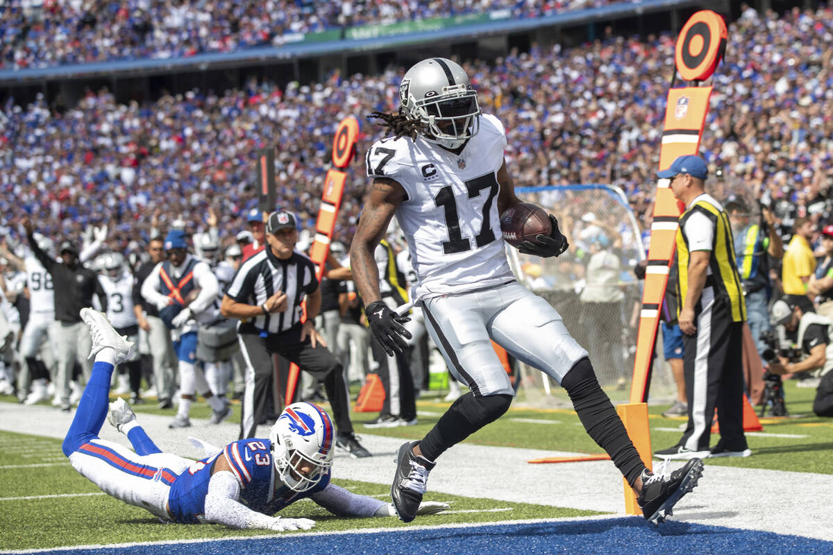 Las Vegas Raiders wide receiver Davante Adams (17) runs after the catch for a 16 yard touchdown ...