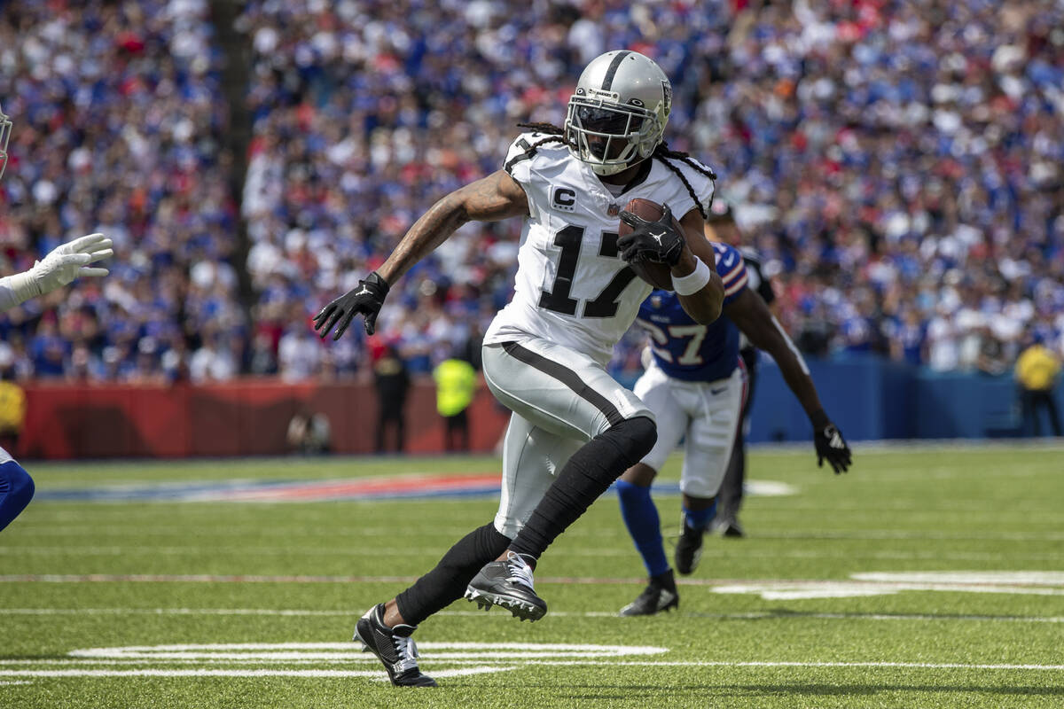 Las Vegas Raiders wide receiver Davante Adams (17) runs after the catch for a 16 yard touchdown ...