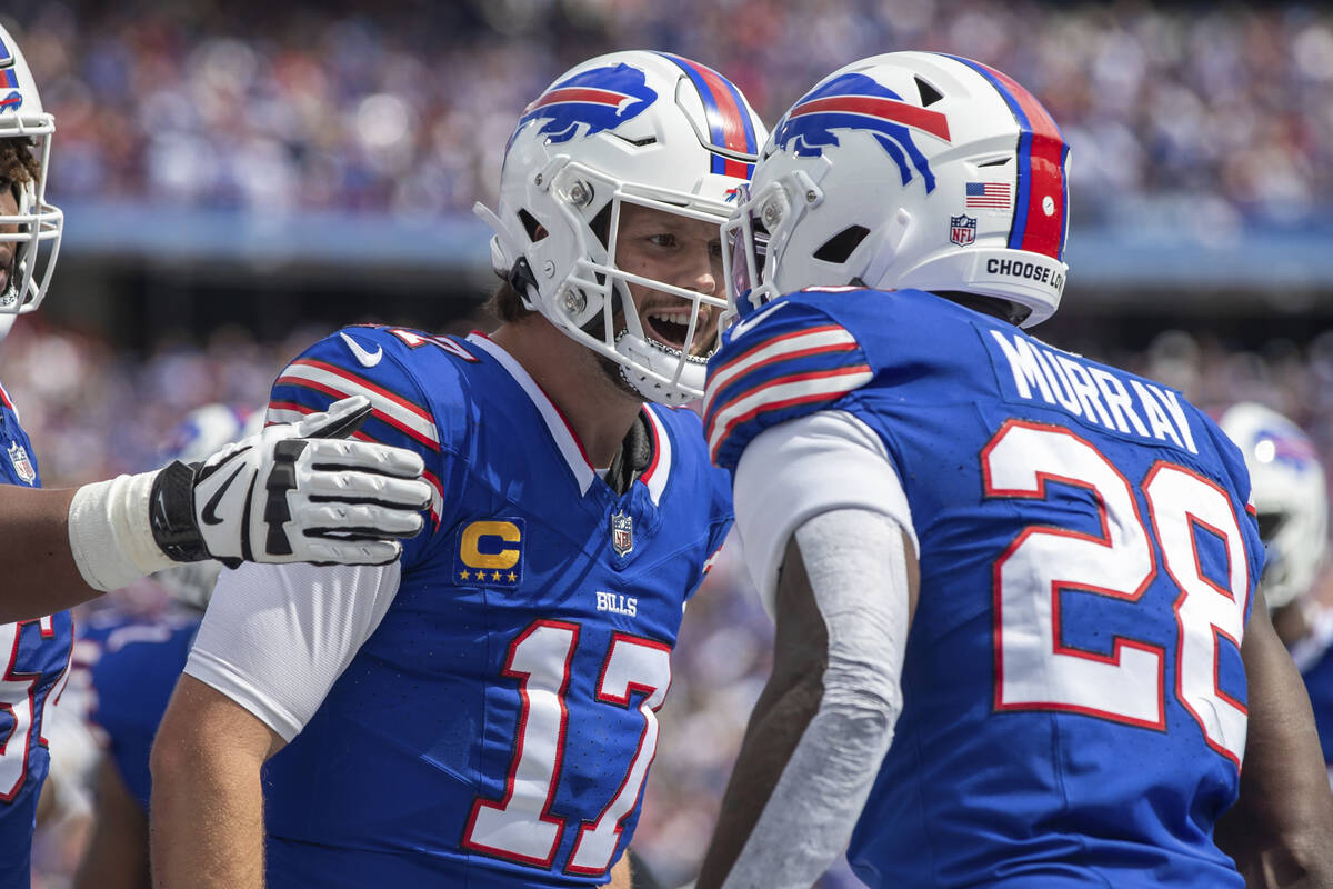 Buffalo Bills quarterback Josh Allen (17) celebrates with running back Latavius Murray (28) aft ...