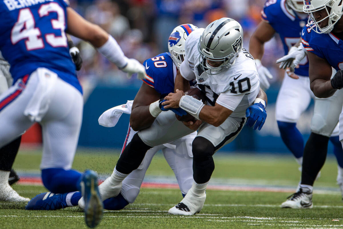 Raiders quarterback Jimmy Garoppolo (10) is sacked by Buffalo Bills defensive end Greg Rousseau ...