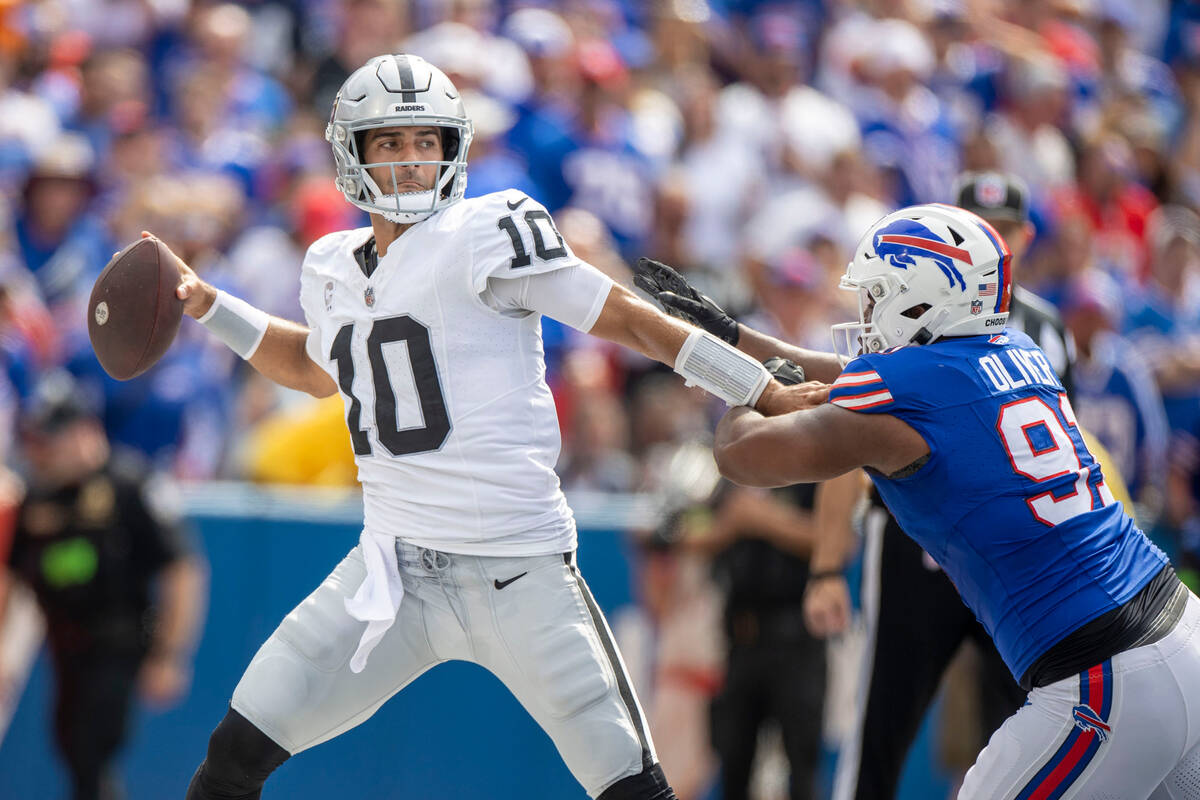 Raiders quarterback Jimmy Garoppolo (10) looks to throw the football away as Buffalo Bills defe ...