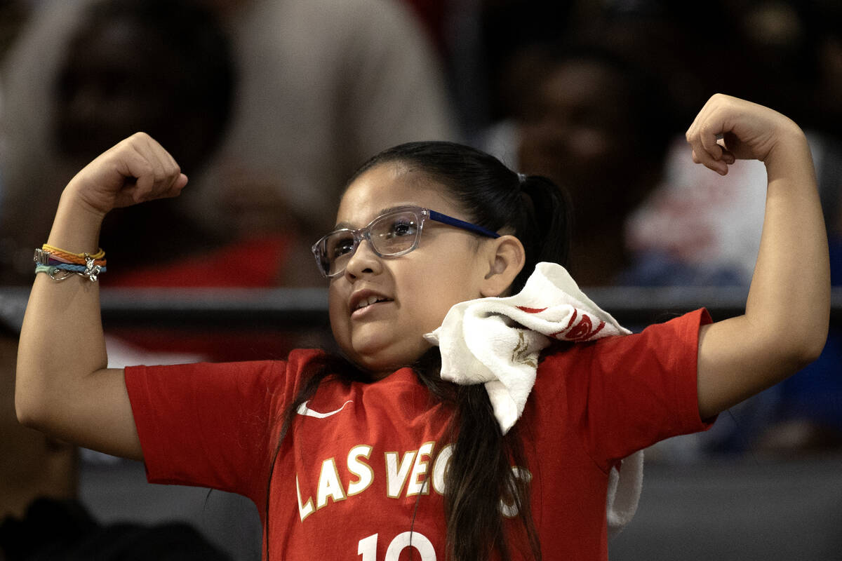 A young Las Vegas Aces fan flexes her muscles during the second half of Game 2 in a first-round ...