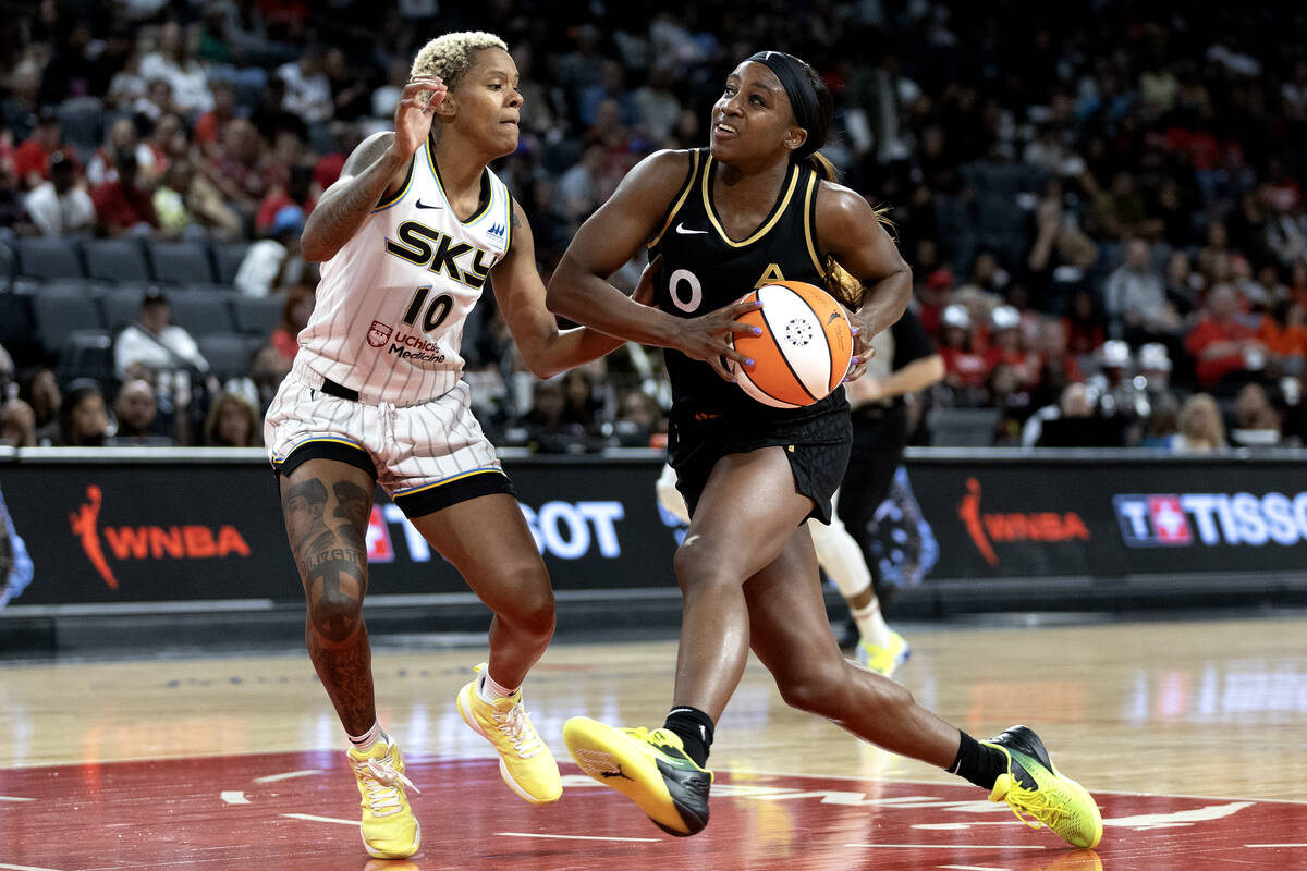 Las Vegas Aces guard Jackie Young (0) drives toward the hoop against Chicago Sky guard Courtney ...
