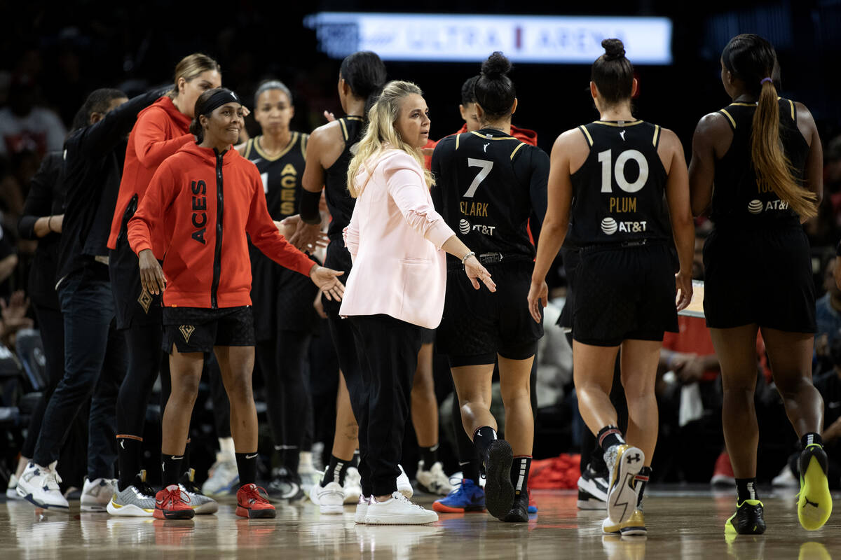 Las Vegas Aces head coach Becky Hammon welcomes her team into a timeout during the second half ...