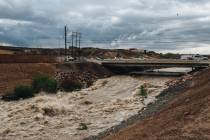 Water rushes through Duck Creek wash, part of the valley's flood control system, after recent r ...