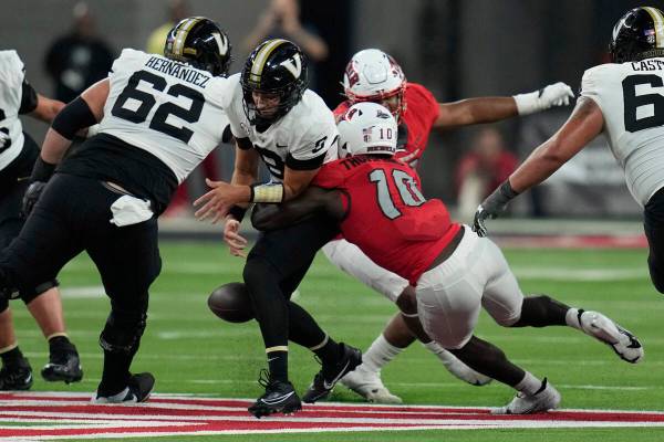 UNLV linebacker Fred Thompkins (10) forces Vanderbilt quarterback Ken Seals (8) to fumble durin ...