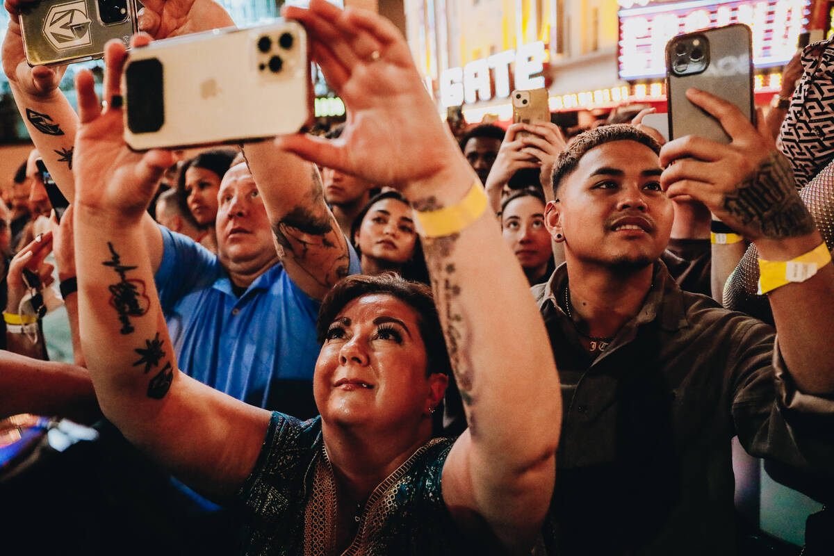 U2 fans watch a surprise performance by the band, who was filming a music video in front of the ...