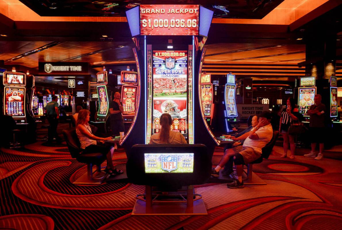 Guests play the first Vegas NFL slot machine at the M Resort in Las Vegas, Monday, Sept. 18, 20 ...