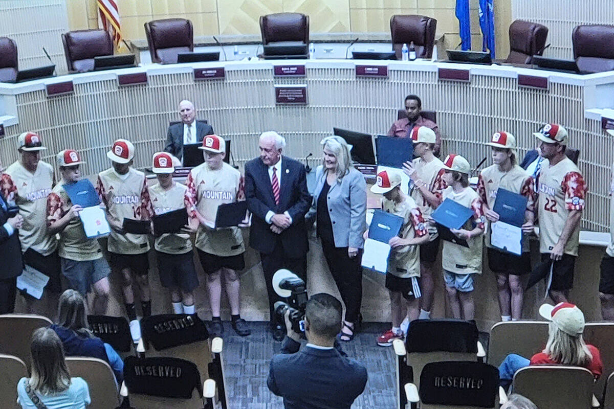 Jim Seebock and Carrie Cox talk to the Henderson All-Stars Little League baseball team in a Hen ...