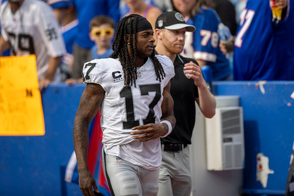 Raiders wide receiver Davante Adams (17) leaves the NFL game against the Buffalo Bills during t ...