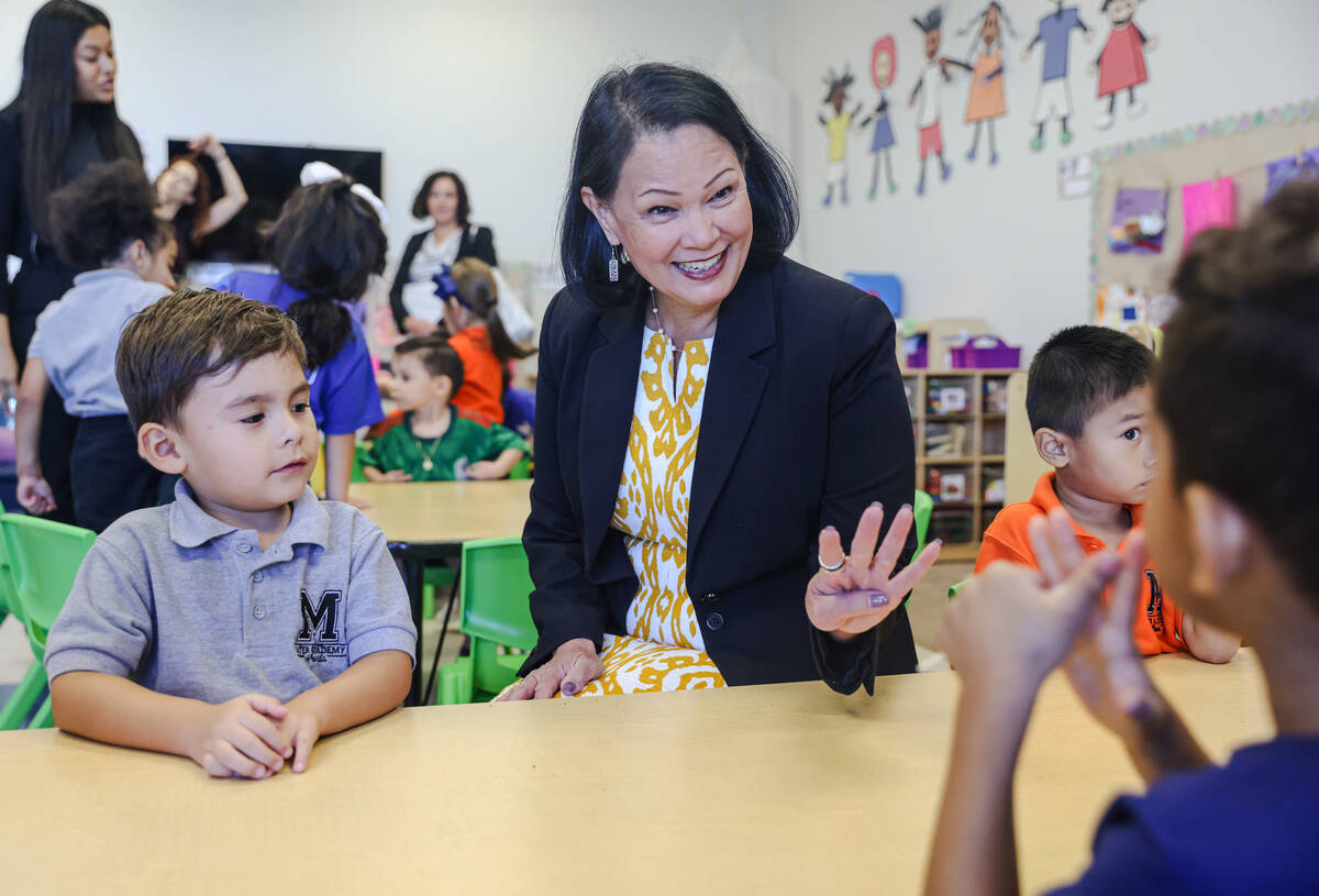 Julian Palomino, 4, left, looks on as Nevada Superintendent of Public Instruction Jhone Ebert, ...