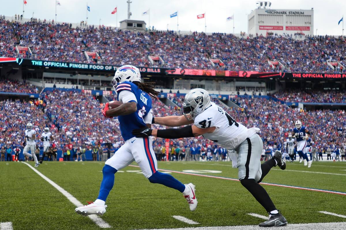 Las Vegas Raiders' Robert Spillane (41) tackles Buffalo Bills' James Cook (4) during the first ...