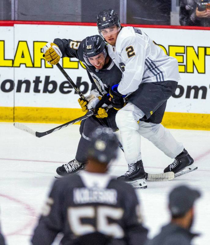 Golden Knights forward Alex Swetlikoff (42) battles for position with defenseman Zach Whiteclou ...