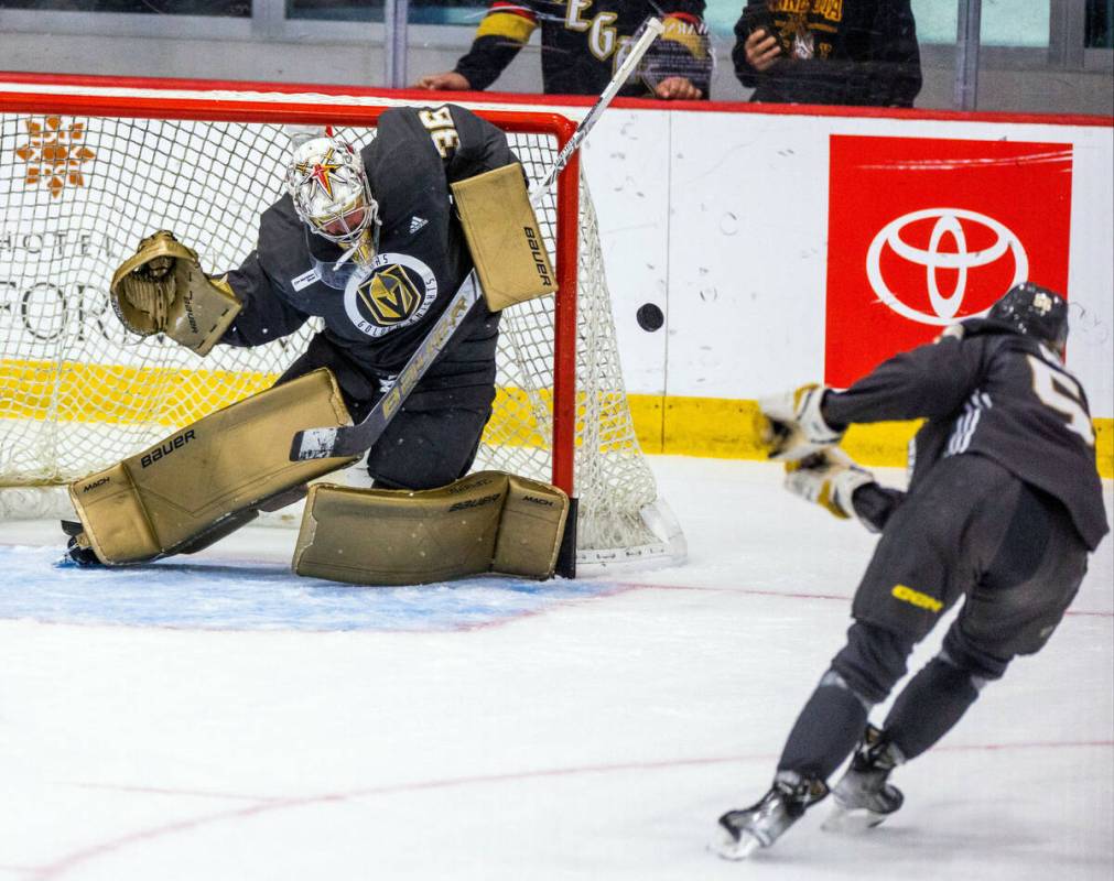 Golden Knights goalie Logan Thompson (36) rejects a shot by defenseman Daniil Chayka (5) during ...