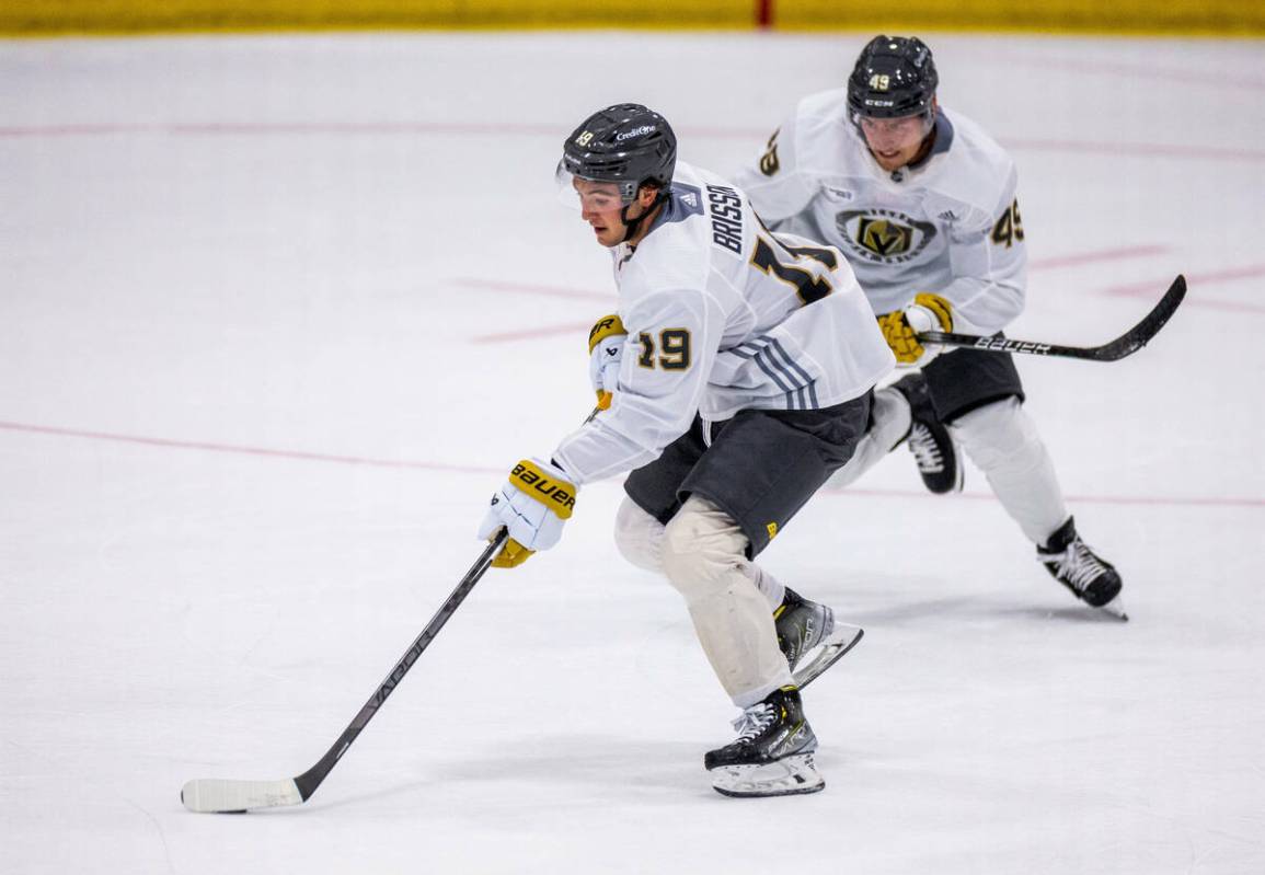 Golden Knights center Brendan Brisson (19) advances the puck flanked by center Ivan Barbashev ( ...