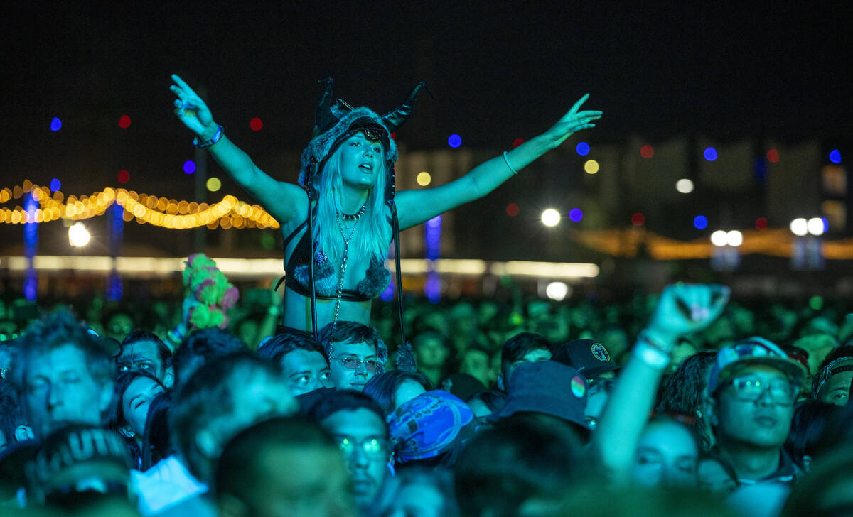 Fans listen while bathed in blue as Modest Mouse performs on the Downtown Stage during day two ...