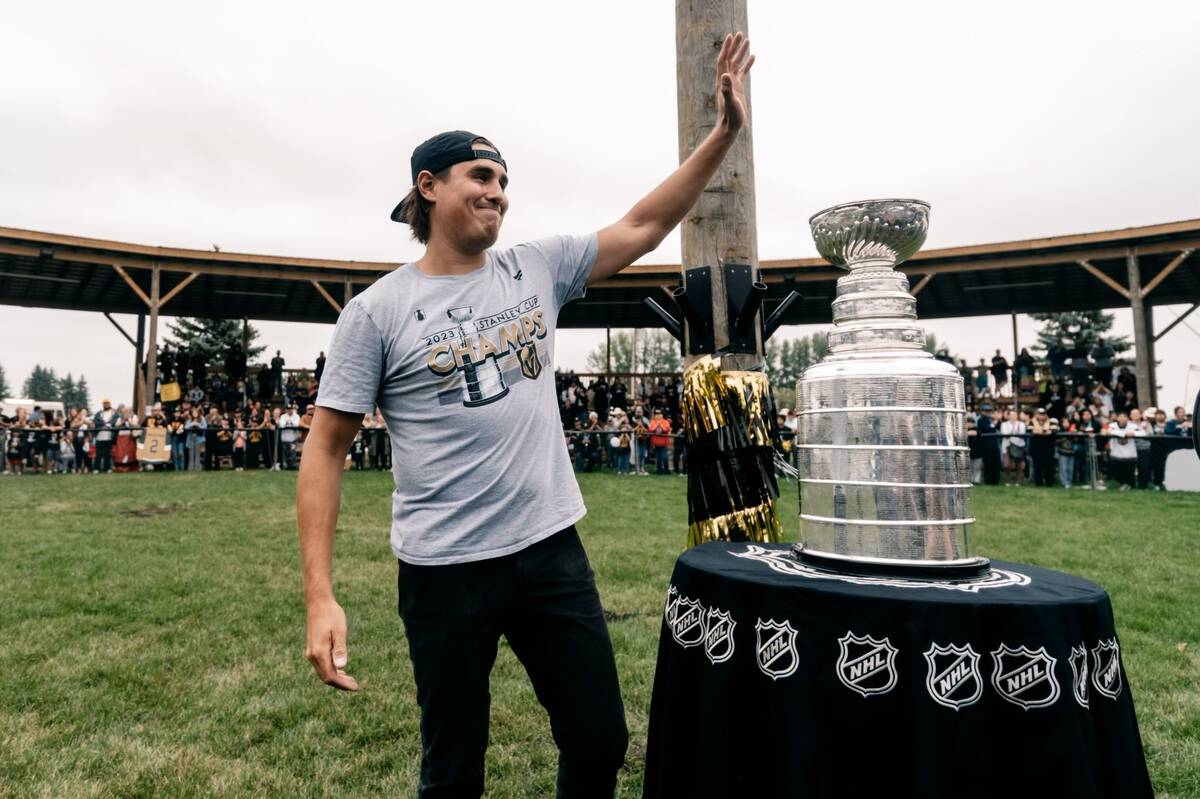 Golden Knights defenseman Zach Whitecloud shows off the Stanley Cup during a visit to the Sioux ...