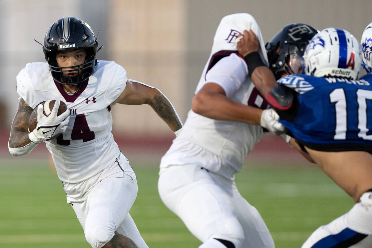 Faith Lutheran running back Cale Breslin (14) looks for an opening to run the ball during the f ...