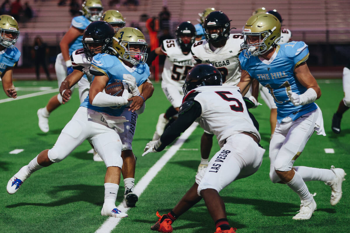 Foothill running back Eugene Altobella III (3) runs the ball as Las Vegas cornerback Treshawn B ...