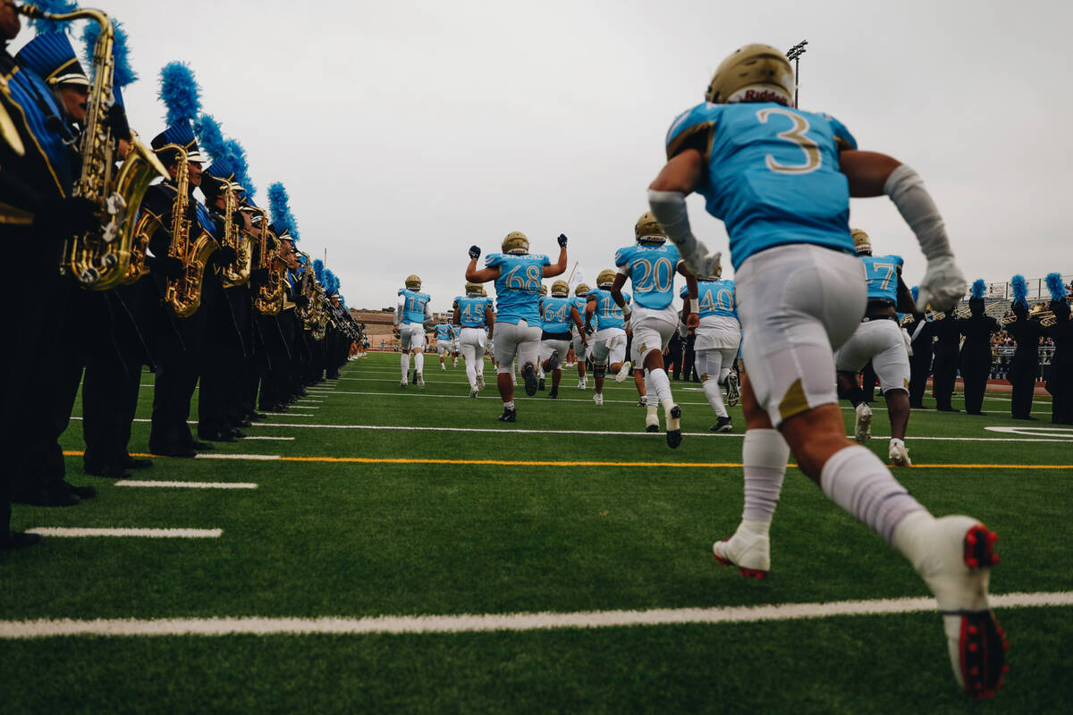 Foothill football players run onto the field before taking on Las Vegas High School in a footba ...