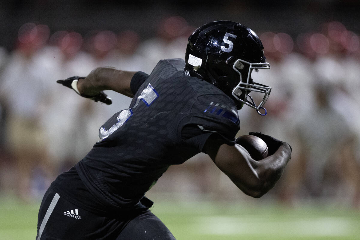 Desert Pines running back Greg Burrell (5) breaks for the end zone during overtime of a high sc ...