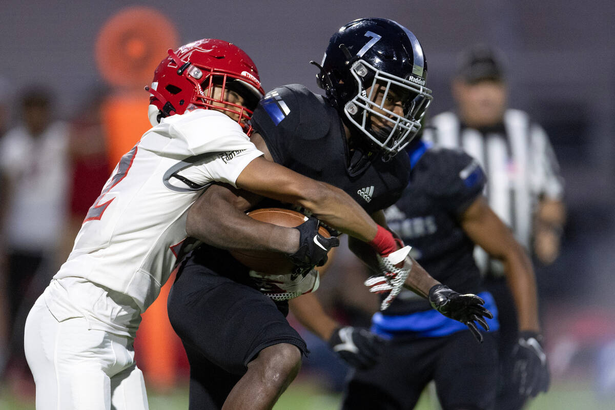 Arbor View cornerback Adrian Peterson (22) attempts to tackle Desert Pines wide receiver Tyrik ...