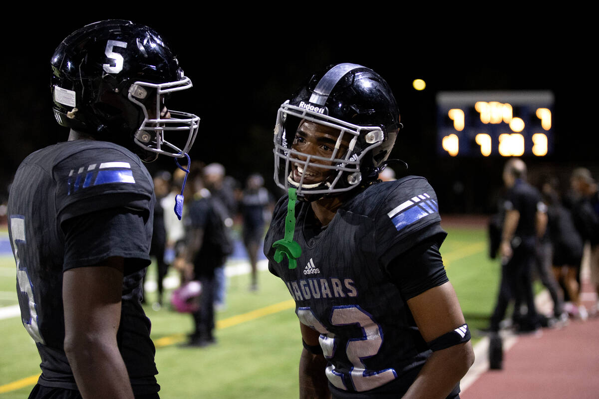 Desert Pines wide receiver Trey Jackson (22) celebrates with running back Greg Burrell (5) afte ...