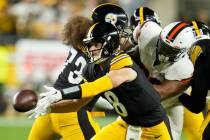 Pittsburgh Steelers quarterback Kenny Pickett pitches during the first half of an NFL football ...
