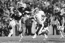 FILE - In this Jan. 22, 1984, file photo, Los Angeles Raiders running back Marcus Allen (32) ou ...