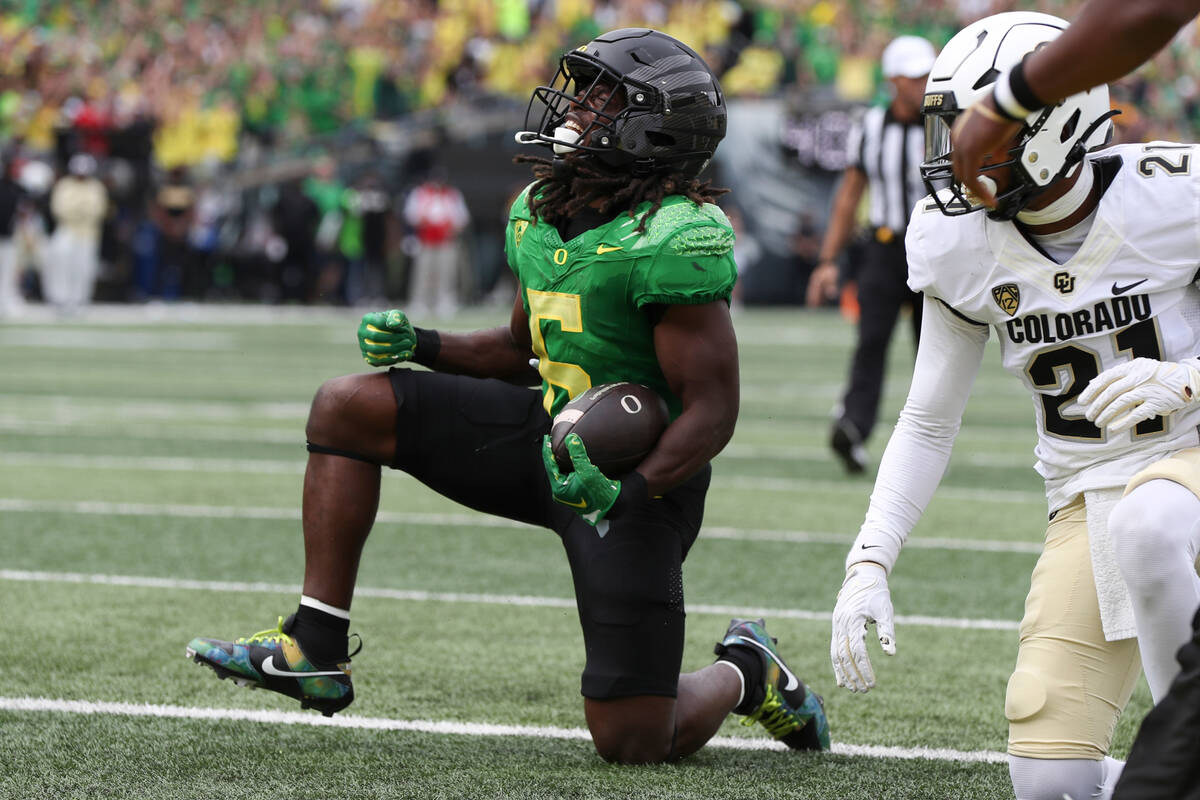 Oregon running back Noah Whittington (6) celebrates after scoring a touchdown against Colorado ...