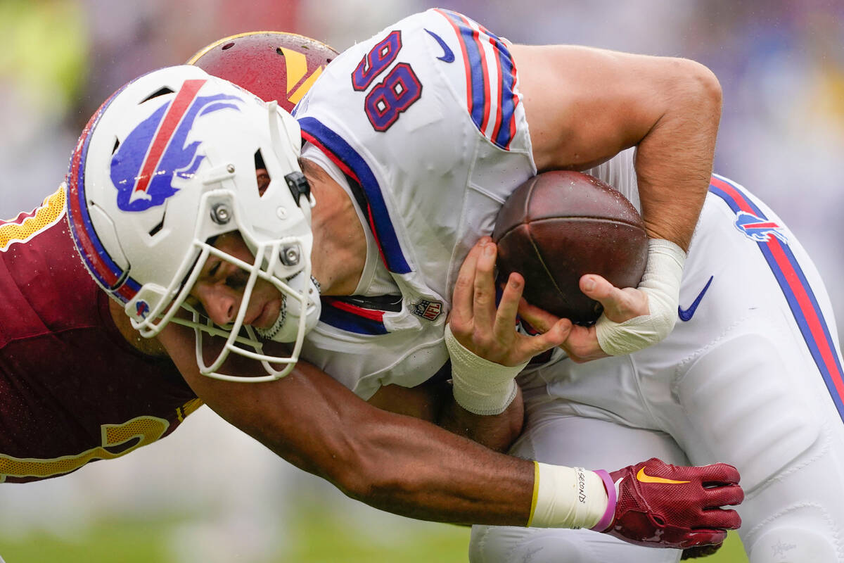 Buffalo Bills tight end Dalton Kincaid (86) is tackled by Washington Commanders cornerback Kend ...