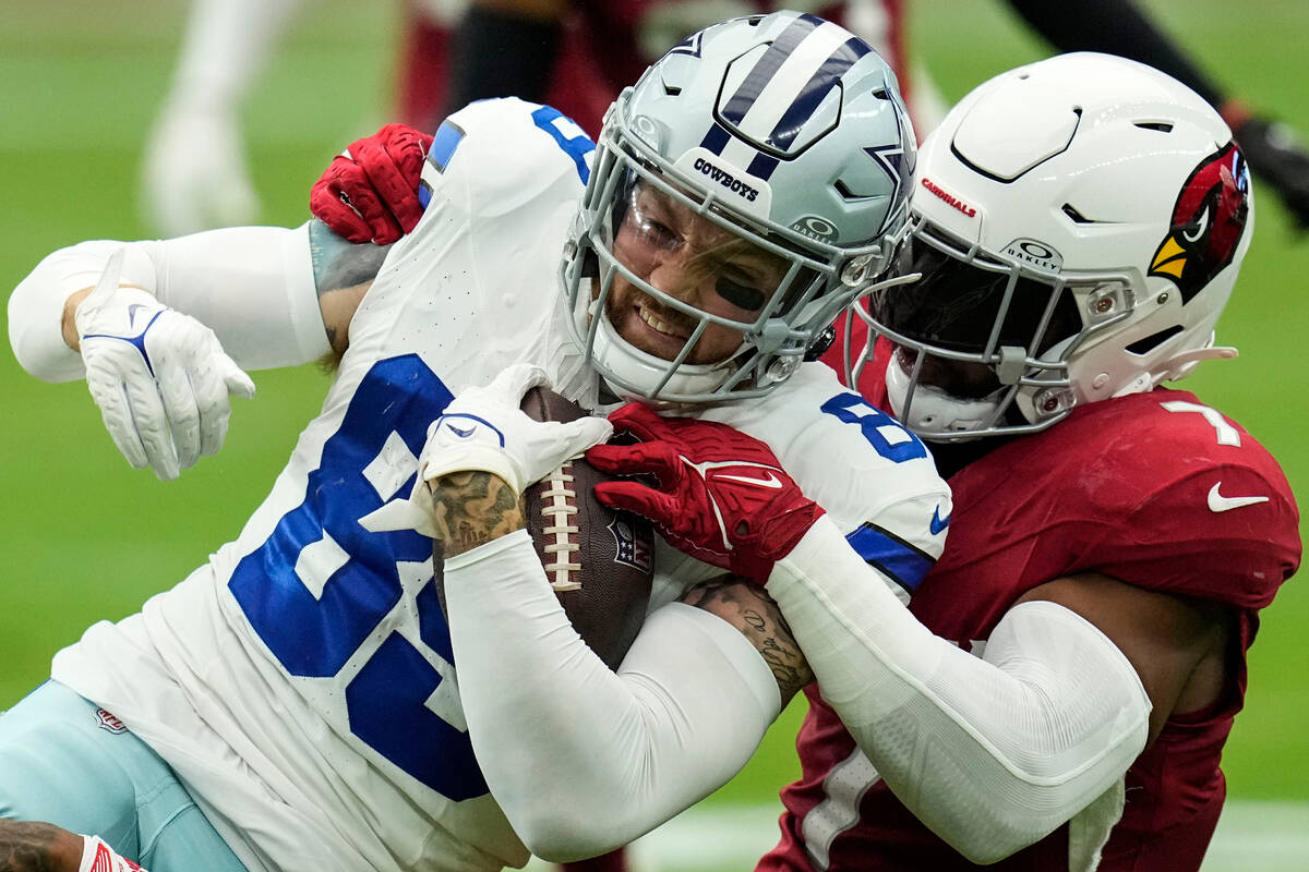 Dallas Cowboys tight end Peyton Hendershot (89) is hit by Arizona Cardinals linebacker Kyzir Wh ...