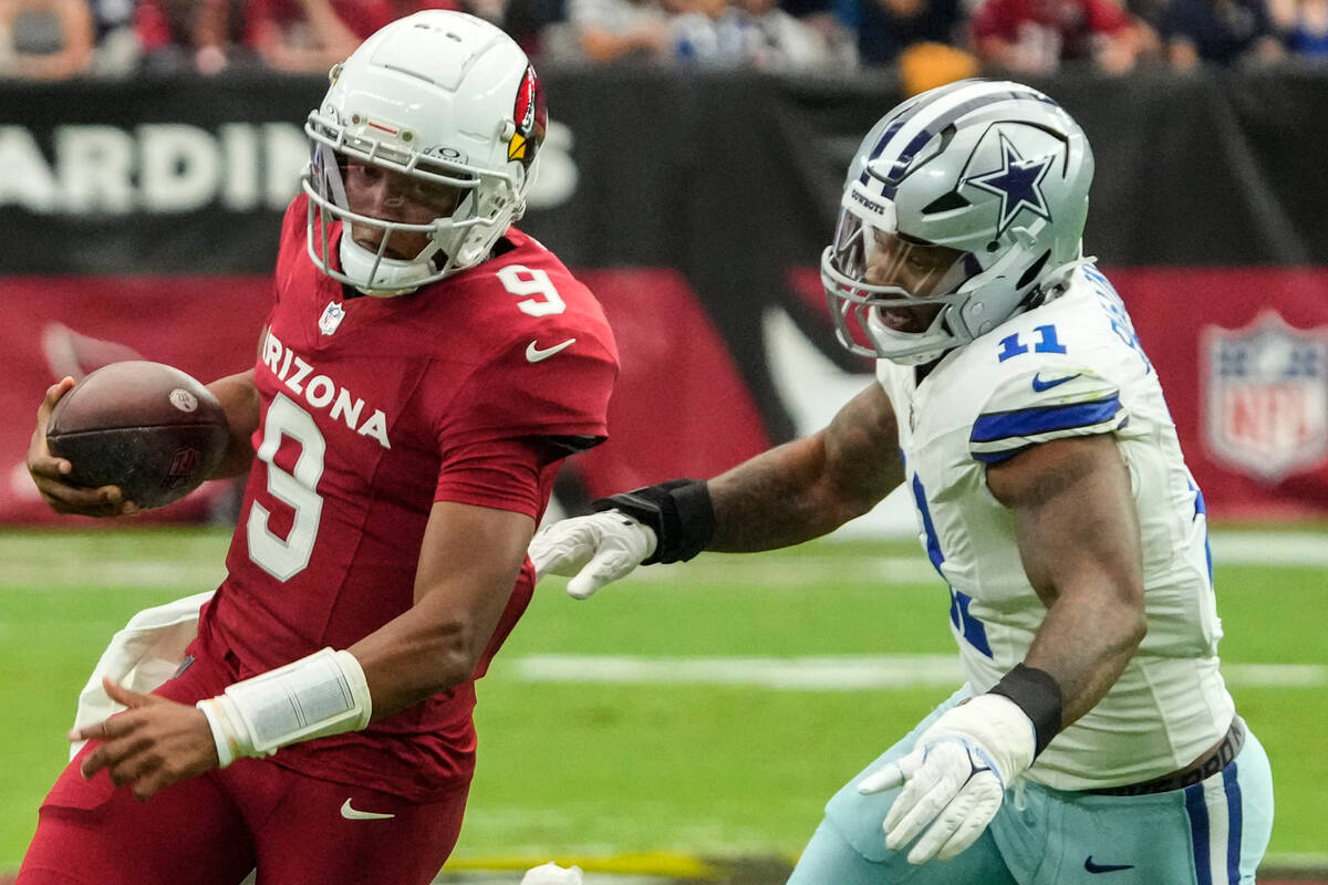 Arizona Cardinals quarterback Joshua Dobbs (9) runs past Dallas Cowboys linebacker Micah Parson ...