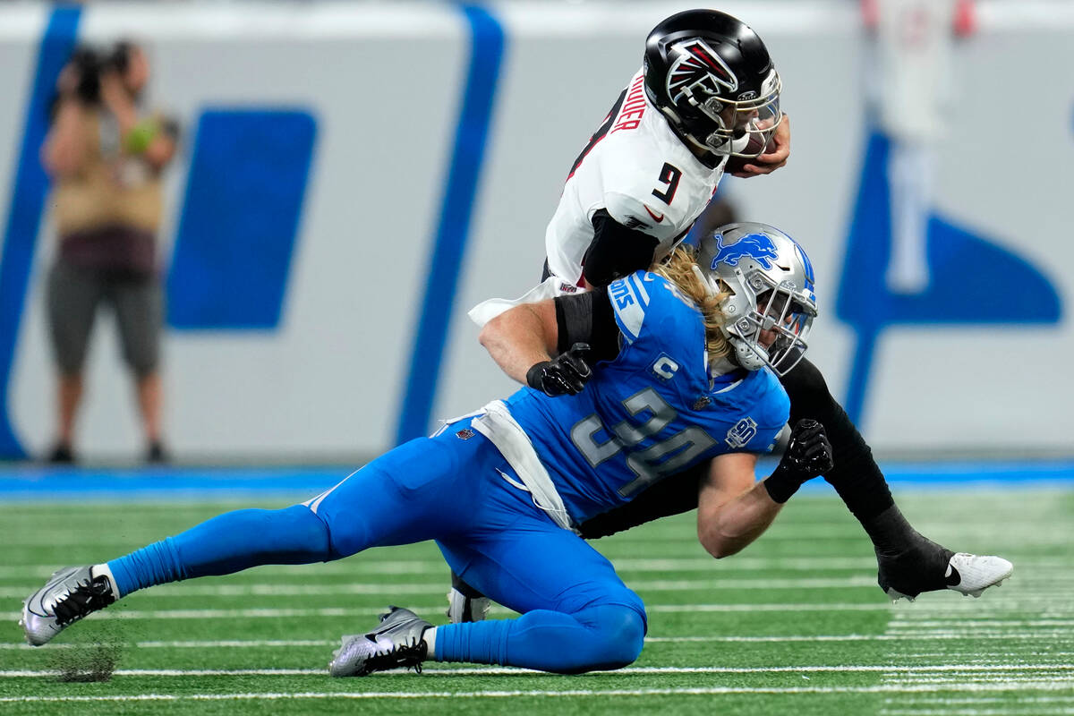 Atlanta Falcons quarterback Desmond Ridder (9) is brought down by Detroit Lions linebacker Alex ...