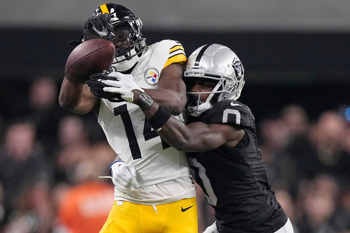 Las Vegas Raiders cornerback Jakorian Bennett, right, breaks up a pass intended for Pittsburgh ...