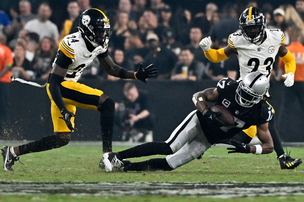 Las Vegas Raiders wide receiver Davante Adams makes a catch next to Pittsburgh Steelers cornerb ...