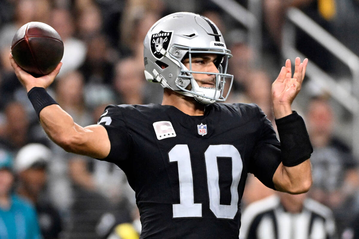 Las Vegas Raiders quarterback Jimmy Garoppolo throws during the first half of an NFL football g ...