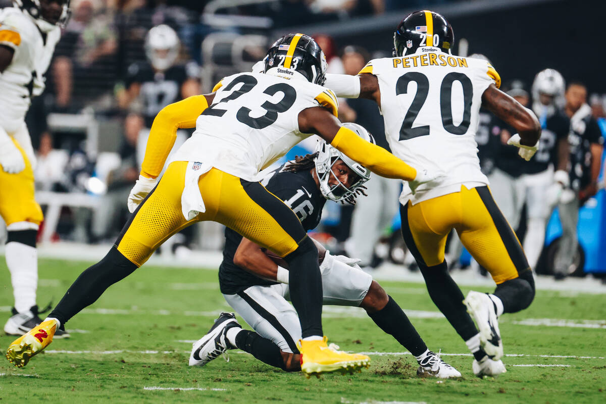 Raiders wide receiver Jakobi Meyers (16) goes down with the ball as Pittsburgh Steelers safety ...