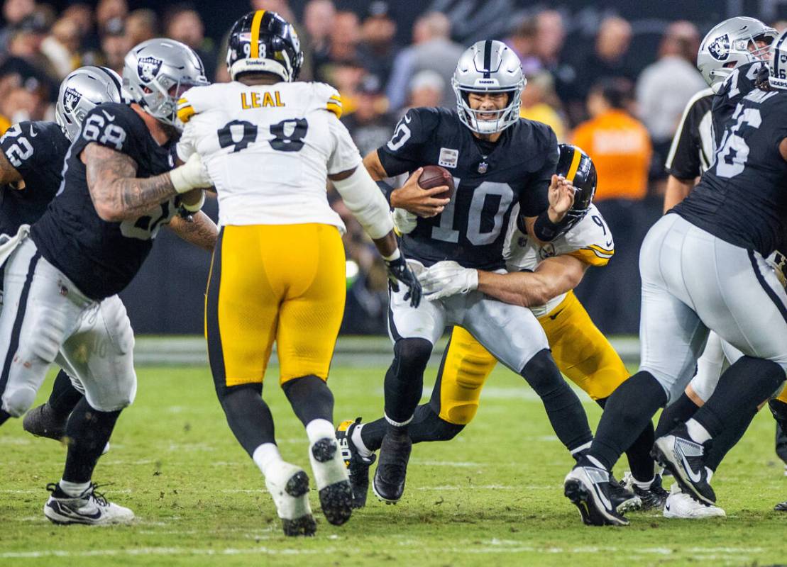 Raiders quarterback Jimmy Garoppolo (10) is sacked and injured while sacked by Pittsburgh Steel ...