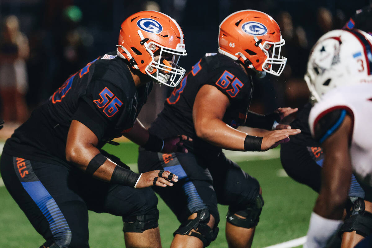 Bishop Gorman offensive linemen Doug Utu (56) and Sj Seuseu Alofaituli (65) position themselves ...