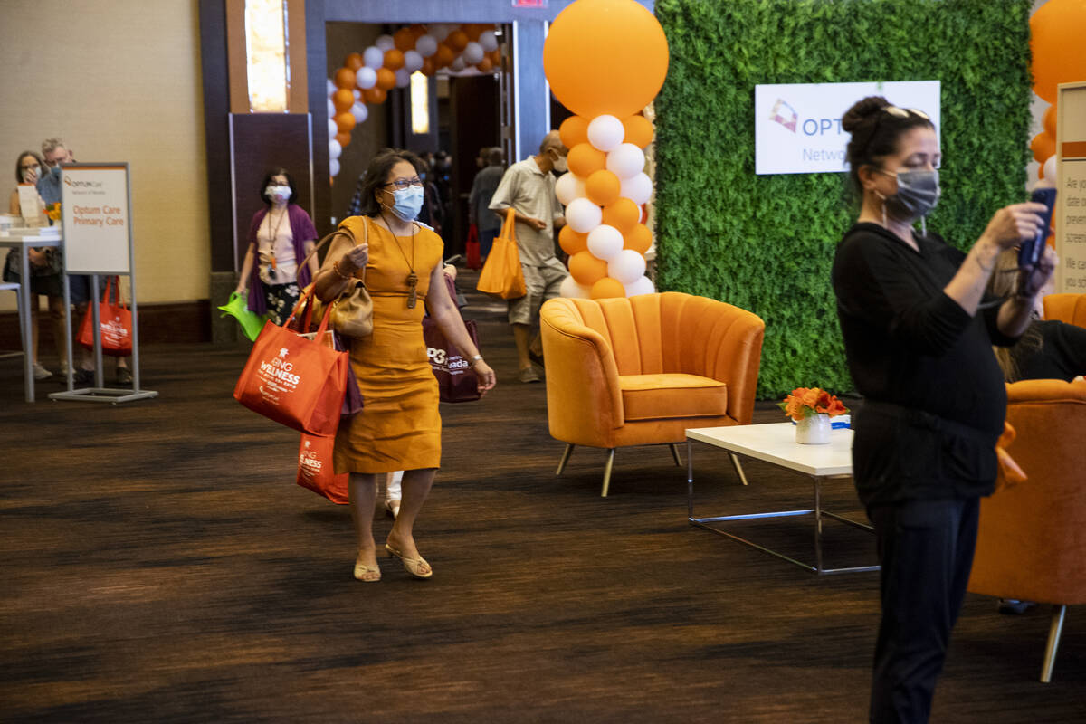 People visit the Optum Care booth during the Aging Wellness Expo at Red Rock Resort in Las Vega ...