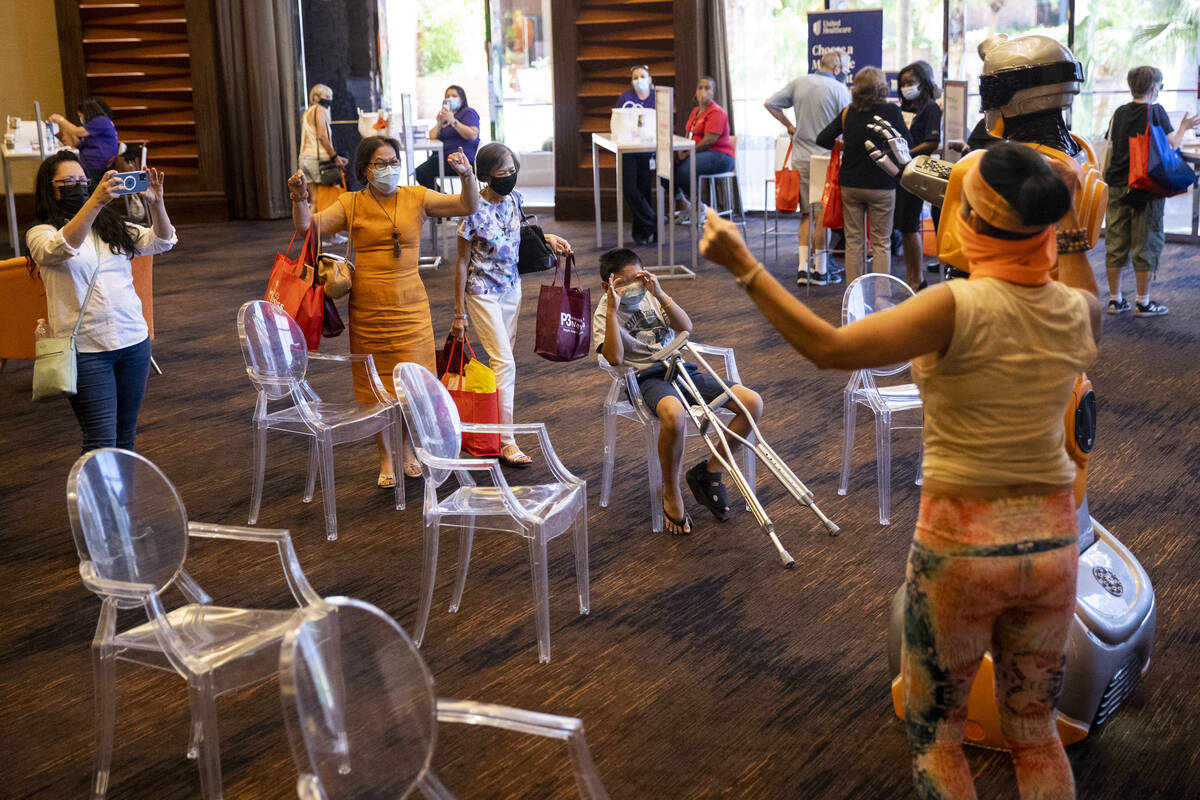 People visit the Optum Care booth during the Aging Wellness Expo at Red Rock Resort in Las Vega ...