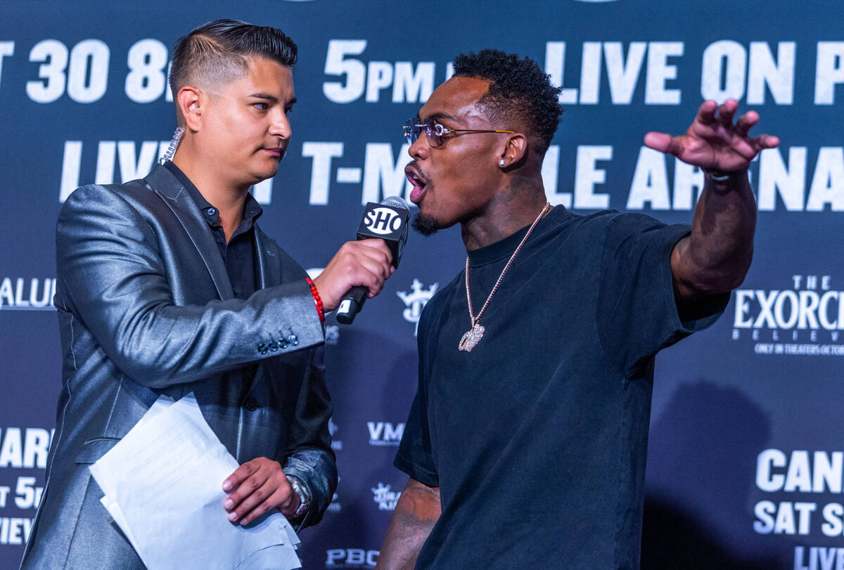 Fight commentator Miguel Flores, left, listens as Jermell Charlo talks about his personally pre ...